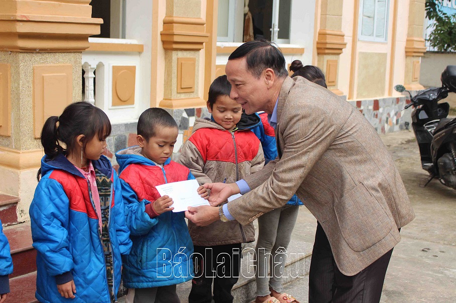 Đồng chí Nguyễn Viết Mạnh-Chủ tịch Hội nhà báo tỉnh tặng quà cho học sinh nghèo trường Tiểu học xã Hua Bum.