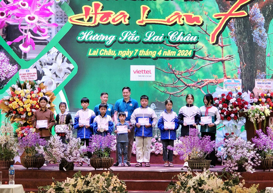 Đại diện CLB Hoa lan Lai Châu tặng quà cho học sinh có hoàn cảnh khó khăn trên địa bàn thành phố Lai Châu. 