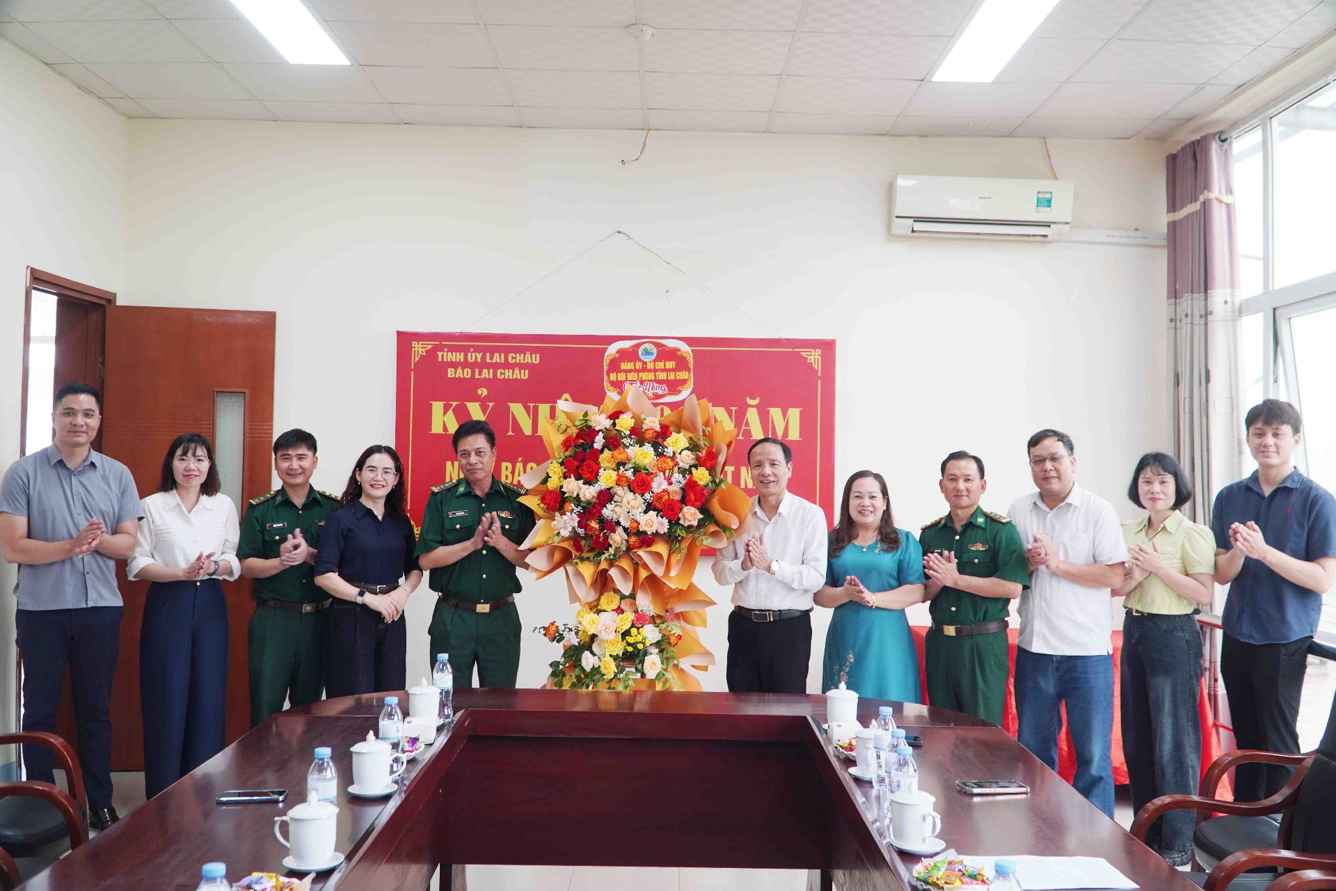 Đồng chí Lê Công Thành -  Phó Chính uỷ Bộ đội Biên phòng tỉnh tặng hoa chúc mừng Báo Lai Châu.